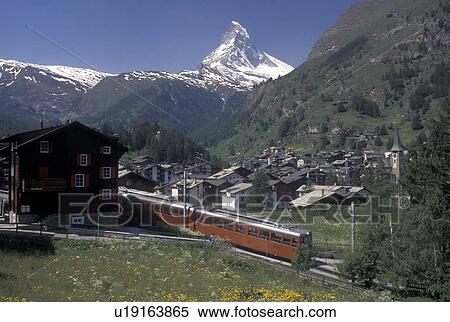 Stock Photography -  train, Switzerland, Zermatt, Valais, Matterhorn, Alps, Gornergrat Bahn (train) travels through the scenic mountain resort village of Zermatt with a view of the Matterhorn in the Swiss Alps.. Fotosearch