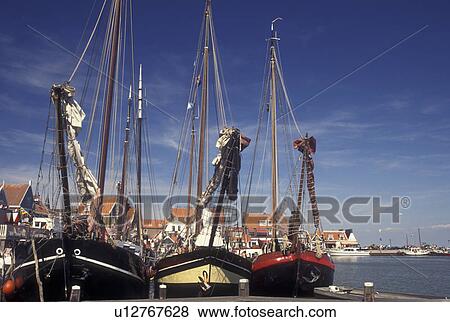 Stock Photo -  Volendam, Netherlands, Holland, Noord-Holland, Europe, Three tall ships docked on the harbor on Markermeer in the town of Volendam.. Fotosearch