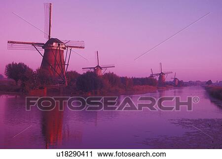 windmill, canal, Kinderdijk, Holland, Netherlands, Zuid-Holland, Europe, Mills of Kinderdijk, Working windmills along a canal in the early morning in Kinderdijk. View Large Photo Image Stock Image - windmill, canal, Kinderdijk, Holland, Netherlands, Zuid-Holland, Europe, Mills of Kinderdijk, Working windmills along a canal in the early morning in Kinderdijk. . Fotosearch