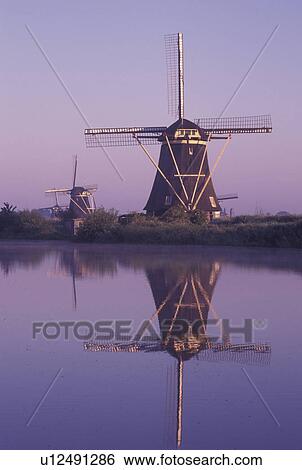 windmill, canal, Kinderdijk, Holland, Netherlands, Zuid-Holland, Europe, Mills of Kinderdijk, Working windmills along a canal in the early morning in Kinderdijk. View Large Photo Image Stock Photograph - windmill, canal, Kinderdijk, Holland, Netherlands, Zuid-Holland, Europe, Mills of Kinderdijk, Working windmills along a canal in the early morning in Kinderdijk. . Fotosearch