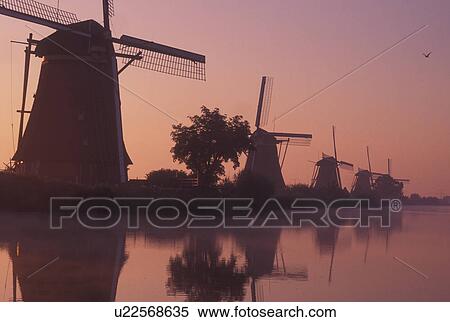 windmill, canal, Kinderdijk, Netherlands, Holland, Zuid-Holland, Europe, Mills of Kinderdijk, Working windmills along a canal in the early morning mist in Kinderdijk. View Large Photo Image Stock Photography - windmill, canal, Kinderdijk, Netherlands, Holland, Zuid-Holland, Europe, Mills of Kinderdijk, Working windmills along a canal in the early morning mist in Kinderdijk. . Fotosearch