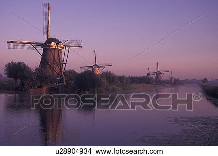 windmill, canal, Netherlands, Kinderdijk, Holland, Zuid-Holland, Europe, Mills of Kinderdijk, Working windmills along a canal in the early morning in Kinderdijk. View Large Photo Image Picture - windmill, canal, Netherlands, Kinderdijk, Holland, Zuid-Holland, Europe, Mills of Kinderdijk, Working windmills along a canal in the early morning in Kinderdijk. . Fotosearch