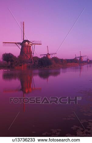 windmill, canal, Netherlands, Kinderdijk, Holland, Zuid-Holland, Europe, Mills of Kinderdijk, Working windmills along a canal in the early morning in Kinderdijk. View Large Photo Image Stock Image - windmill, canal, Netherlands, Kinderdijk, Holland, Zuid-Holland, Europe, Mills of Kinderdijk, Working windmills along a canal in the early morning in Kinderdijk. . Fotosearch