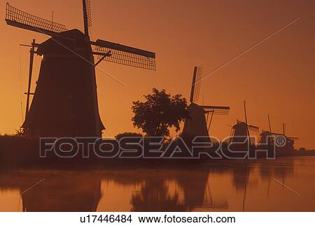 windmill, Netherlands, Kinderdijk, Holland, Zuid-Holland, Europe, Mills of Kinderdijk, Working windmills along a canal in the early morning mist in Kinderdijk. View Large Photo Image Picture - windmill, Netherlands, Kinderdijk, Holland, Zuid-Holland, Europe, Mills of Kinderdijk, Working windmills along a canal in the early morning mist in Kinderdijk. . Fotosearch