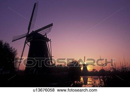 windmill, sunrise, Kinderdijk, Holland, Netherlands, Zuid-Holland, Europe, Mills of Kinderdijk, Working windmills along a canal in Kinderdijk at sunrise. View Large Photo Image Stock Photo - windmill, sunrise, Kinderdijk, Holland, Netherlands, Zuid-Holland, Europe, Mills of Kinderdijk, Working windmills along a canal in Kinderdijk at sunrise.. Fotosearch