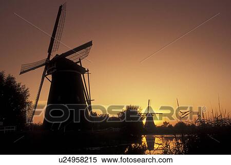 windmill, sunrise, Kinderdijk, Netherlands, Holland, Zuid-Holland, Europe, Mills of Kinderdijk, Working windmills along a canal in Kinderdijk at sunrise. View Large Photo Image Stock Photography - windmill, sunrise, Kinderdijk, Netherlands, Holland, Zuid-Holland, Europe, Mills of Kinderdijk, Working windmills along a canal in Kinderdijk at sunrise.. Fotosearch