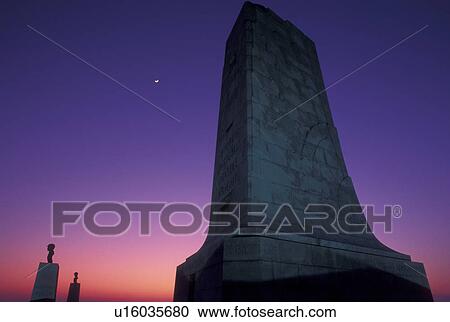 Stock Image -  Wright Brothers National Memorial, North Carolina, Outer Banks, NC, The Wright Memorial Shaft on Kills Devil Hill in the Outer Banks of North Carolina at dusk.. Fotosearch