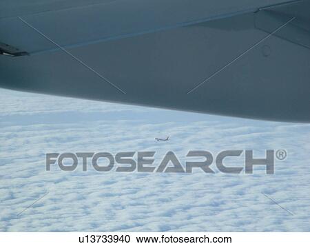 Aerial view of cloud cover from an airplane  View Large Photo Image Stock Image -  Aerial view of cloud cover from an airplane . Fotosearch