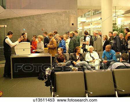 Stock Image -  airport, Philadelphia, PA, Pennsylvania, Passengers waiting to board the plane inside the Philadelphia International Airport in Philadelphia.. Fotosearch