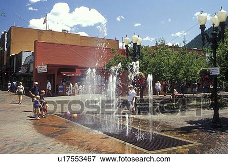 Stock Photo -  Aspen, CO, Colorado, Children playing in fountain in downtown Aspen, resort town. Fotosearch