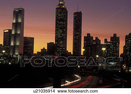Atlanta, GA, Georgia, Downtown skyline, Freedom Parkway, evening, traffic, streaks of car lights along the expressway, road View Large Photo Image Picture - Atlanta, GA, Georgia, Downtown skyline, Freedom Parkway, evening, traffic, streaks of car lights along the expressway, road. Fotosearch