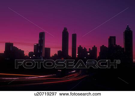 Stock Photo -  Atlanta, GA, Georgia, Downtown skyline, Freedom Parkway, evening, traffic, streaks of car lights along the expressway, road. Fotosearch