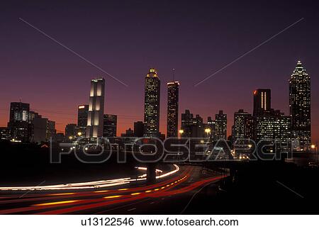 Atlanta, GA, Georgia, Downtown skyline, Freedom Parkway, evening, traffic, streaks of car lights along the expressway, road View Large Photo Image Stock Photograph - Atlanta, GA, Georgia, Downtown skyline, Freedom Parkway, evening, traffic, streaks of car lights along the expressway, road. Fotosearch