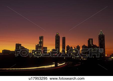 Stock Photography -  Atlanta, GA, Georgia, Downtown skyline, Freedom Parkway, evening, traffic, streaks of car lights along the expressway, road. Fotosearch