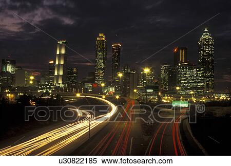 Atlanta, GA, Georgia, Downtown skyline, Freedom Parkway, evening, streaks of car lights along the expressway, road, transportation, traffic View Large Photo Image Stock Photography - Atlanta, GA, Georgia, Downtown skyline, Freedom Parkway, evening, streaks of car lights along the expressway, road, transportation, traffic. Fotosearch