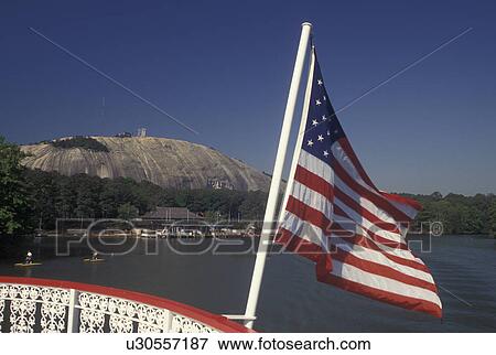 Stock Photo -  Atlanta, GA, Georgia, Georgia Stone Mountain Park, Paddle Wheel Riverboat on Stone Mountain Lake, American Flag. Fotosearch