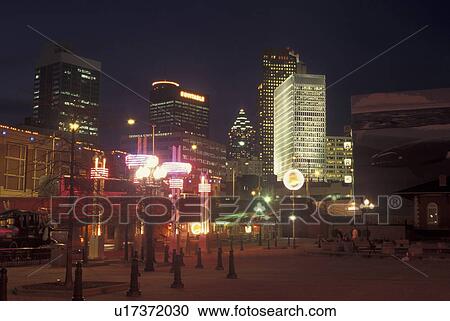 Stock Image -  Atlanta, GA, Georgia, Underground Atlanta, evening, downtown skyline. Fotosearch