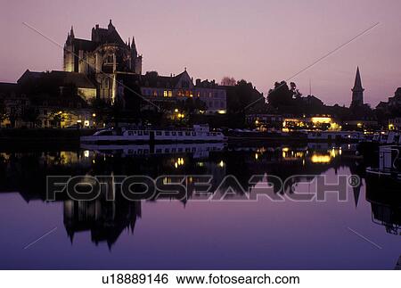 Stock Photograph -  Auxerre, Burgundy, France, Bourgogne, Yonne, Europe, wine region, Reflection of the Cathedral St. Etienne in the Yonne River in the evening in the city of Auxerre.. Fotosearch