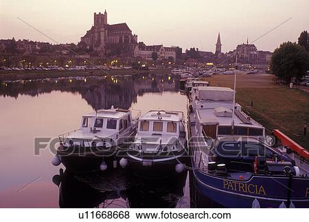 Auxerre, France, Burgundy, Bourgogne, Yonne, Europe, wine region, View of the Cathedral St. Etienne and house barges along the Yonne River in the evening in the city of Auxerre. View Large Photo Image Stock Photo - Auxerre, France, Burgundy, Bourgogne, Yonne, Europe, wine region, View of the Cathedral St. Etienne and house barges along the Yonne River in the evening in the city of Auxerre.. Fotosearch