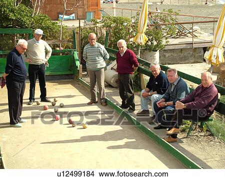 Picture -  bocce, Italy, Liguria, Sestri Levante, Riviera di Levante, Ligurian Riviera, Europe, Senior Italian men playing the game of Bocce on the waterfront in Sestri Levante along the Ligurian Sea.. Fotosearch