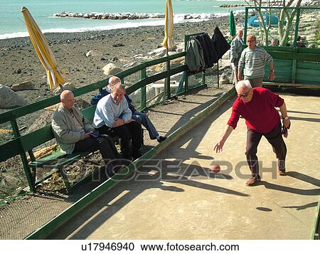 bocce, Italy, Liguria, Sestri Levante, Riviera di Levante, Ligurian Riviera, Europe, Men playing the game of Bocce on the waterfront in Sestri Levante along the Ligurian Sea. View Large Photo Image Stock Image - bocce, Italy, Liguria, Sestri Levante, Riviera di Levante, Ligurian Riviera, Europe, Men playing the game of Bocce on the waterfront in Sestri Levante along the Ligurian Sea.. Fotosearch
