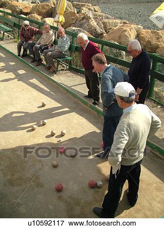 bocce, Italy, Liguria, Sestri Levante, Riviera di Levante, Ligurian Riviera, Europe, Senior Italian men playing the game of Bocce on the waterfront in Sestri Levante along the Ligurian Sea. View Large Photo Image Stock Photo - bocce, Italy, Liguria, Sestri Levante, Riviera di Levante, Ligurian Riviera, Europe, Senior Italian men playing the game of Bocce on the waterfront in Sestri Levante along the Ligurian Sea.. Fotosearch