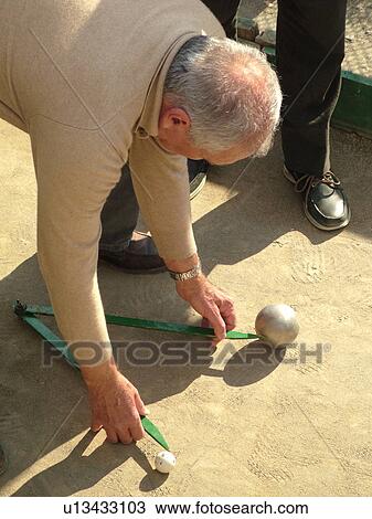 bocce, Liguria, Italy, Sestri Levante, Riviera di Levante, Ligurian Riviera, Europe, Senior Italian men playing the game of Bocce, measuring distance, on the waterfront in Sestri Levante along the Ligurian Sea. View Large Photo Image Stock Image - bocce, Liguria, Italy, Sestri Levante, Riviera di Levante, Ligurian Riviera, Europe, Senior Italian men playing the game of Bocce, measuring distance, on the waterfront in Sestri Levante along the Ligurian Sea.. Fotosearch