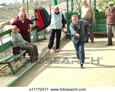 bocce, Liguria, Italy, Sestri Levante, Riviera di Levante, Ligurian Riviera, Europe, Senior Italian men playing the game of Bocce on the waterfront in Sestri Levante along the Ligurian Sea. View Large Photo Image Stock Photo - bocce, Liguria, Italy, Sestri Levante, Riviera di Levante, Ligurian Riviera, Europe, Senior Italian men playing the game of Bocce on the waterfront in Sestri Levante along the Ligurian Sea.. Fotosearch