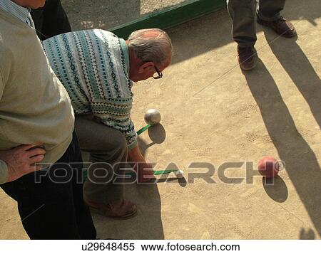 bocce, Liguria, Italy, Sestri Levante, Riviera di Levante, Ligurian Riviera, Europe, Senior Italian men playing the game of Bocce, measuring distance, on the waterfront in Sestri Levante along the Ligurian Sea. View Large Photo Image Stock Photography - bocce, Liguria, Italy, Sestri Levante, Riviera di Levante, Ligurian Riviera, Europe, Senior Italian men playing the game of Bocce, measuring distance, on the waterfront in Sestri Levante along the Ligurian Sea.. Fotosearch