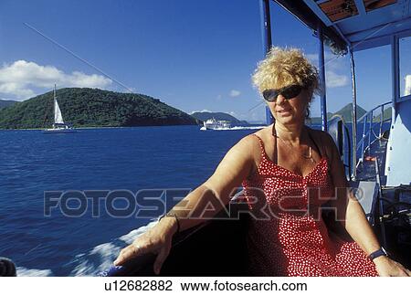 Stock Image -  British Virgin Islands, Caribbean, BVI, Woman sitting on a passenger ferry to Jost Van Dyke Island on the Caribbean Sea.. Fotosearch