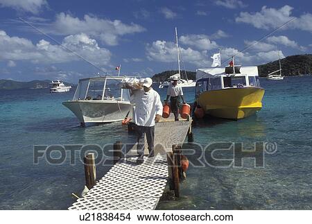 British Virgin Islands, Peter Island, Caribbean, BVI, Unloading at the boat dock on Peter Island on the Caribbean Sea. View Large Photo Image Picture - British Virgin Islands, Peter Island, Caribbean, BVI, Unloading at the boat dock on Peter Island on the Caribbean Sea.. Fotosearch