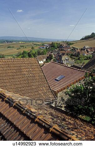 Stock Image -  Burgundy, France, Montagny-les-Buxy, Saone-et-Loire, Bourgogne, Europe, wine region, Scenic view of the rooftops and countryside in the town of Montagny-les-Buxy in the wine region of Burgundy in early spring.. Fotosearch
