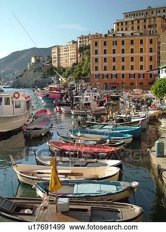 Stock Photo -  Camogli, Riviera di Levante, Liguria, Italy, Ligurian Riviera, Europe, Fishing boats docked along the waterfront of the fishing port in the resort town of Camogli along the Ligurian Sea.. Fotosearch