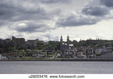 Stock Photograph -  Canada, Chicoutimi, Quebec, The town of Chicoutimi along the Saguenay River.. Fotosearch
