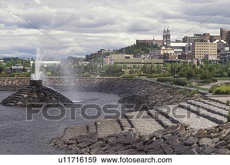 Stock Photo -  Canada, Chicoutimi, Quebec, Waterfront park in the town of Chicoutimi along the Saguenay River.. Fotosearch