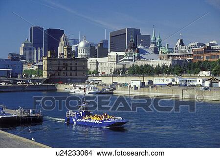 Canada, Montreal, Quebec, Saute Moutons excursion boat cruises in Vieux Port along the St. Lawrence River (Fleuve Saint-Laurent). Skyline of downtown Montreal. View Large Photo Image Picture - Canada, Montreal, Quebec, Saute Moutons excursion boat cruises in Vieux Port along the St. Lawrence River (Fleuve Saint-Laurent). Skyline of downtown Montreal.. Fotosearch