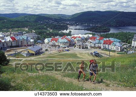 Canada, Quebec, Laurentians, Mount Tremblant, Couple hikes up the mountain with a scenic view of the Tremblant Resort in the Laurentian Mountains and Lac Tremblant. View Large Photo Image Stock Image - Canada, Quebec, Laurentians, Mount Tremblant, Couple hikes up the mountain with a scenic view of the Tremblant Resort in the Laurentian Mountains and Lac Tremblant.. Fotosearch