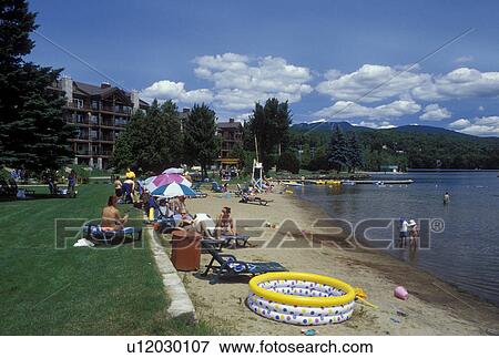 Canada, Quebec, Laurentians, Mount Tremblant, People at Le Grand Lodge Beach along Lac Quimet in Mount-Tremblant. View Large Photo Image Stock Photo - Canada, Quebec, Laurentians, Mount Tremblant, People at Le Grand Lodge Beach along Lac Quimet in Mount-Tremblant.. Fotosearch