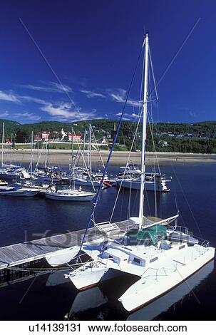 Stock Image -  Canada, Tadoussac, Quebec, Catamaran docked at a marina on the St. Lawrence (Fleuve Saint-Laurent) and Saguenay Rivers in the summer resort town of Tadoussac.. Fotosearch