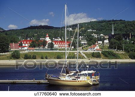 Stock Image -  Canada, Tadoussac, Quebec, Sailboats docked at the marina on the St. Lawrence (Fleuve Saint-Laurent) and Saguenay Rivers in the summer resort town of Tadoussac.. Fotosearch