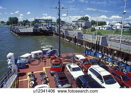 Stock Photograph -  car ferry, St. Ignace-de-Loyola, Canada, Quebec, Sorrel-St. Ignace-de-Loyola car ferry crosses the St. Lawrence River (Fleuve Saint-Laurent) from the ferry terminal at St. Ignace-de-Loyola.. Fotosearch
