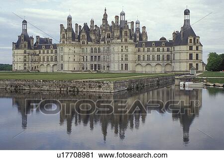 Stock Image -  Chateau de Chambord, France, Chambord, Europe, Loire-et-Cher, Centre, Loire Castle Region, Loire Valley, 16th century Chateau de Chambord reflects in the water in the Loire Castle Region.. Fotosearch