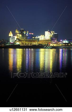 Stock Image -  Cincinnati, OH, Ohio, Downtown skyline along the Ohio River, evening. Fotosearch