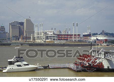 Stock Image -  Cincinnati, OH, Ohio, Downtown skyline along the Ohio River, Great American Ball Park, riverboat. Fotosearch