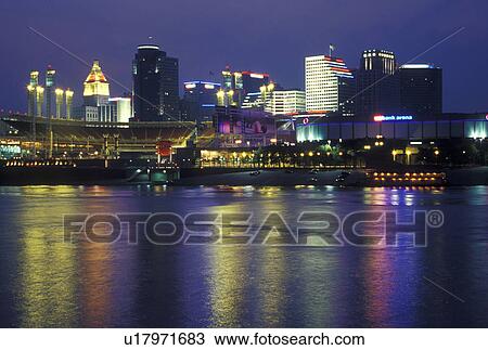 Stock Image -  Cincinnati, OH, Ohio, Downtown skyline along the Ohio River, evening. Fotosearch