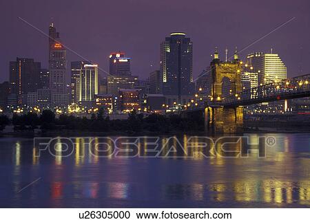 Stock Image -  Cincinnati, OH, Ohio, Downtown skyline along the Ohio River, evening. Fotosearch