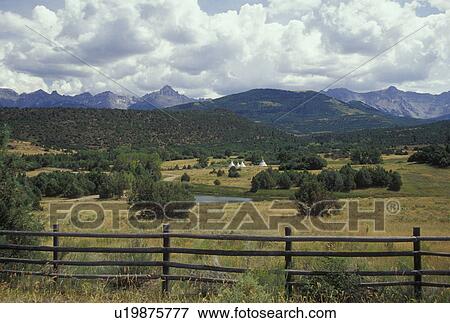 Stock Photo -  CO, Colorado, San Juan National Forest, San Juan Mountains, Mount Sneffels Wilderness, San Juan Skyway, teepees in the distance. Fotosearch