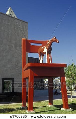 Picture -  Denver, CO, Colorado, Denver Art Museum, horse and giant red chair sculpture. Fotosearch