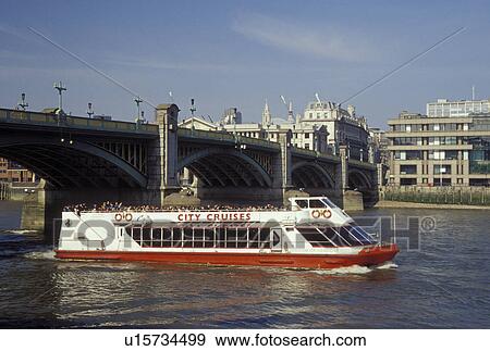 Stock Photo -  England, London, Great Britain, United Kingdom, Europe, Sightseeing tour boat cruises under Southwark Bridge along the River Thames.. Fotosearch