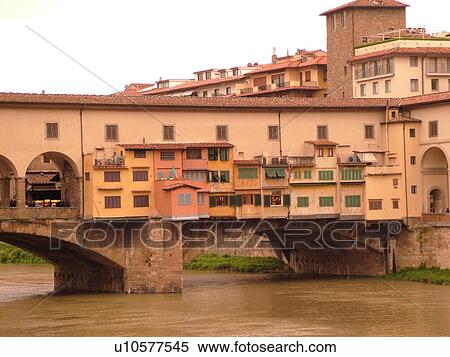 Stock Photography -  Florence, Tuscany, Italy, Firenza, Toscana, Europe, Ponte Vecchio, a bridge lined with shops, crosses the River Arno in the city of Florence.. Fotosearch
